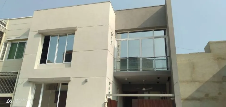 A modern house with a garden and a pathway leading to the entrance