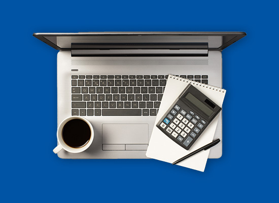 Laptop with calculator and papers