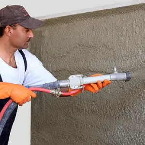 Worker applying dry mix mortars or premix plasters
